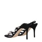 Black satin stiletto heel sandals by Manolo Blahnik featuring elegant open-toe design and sleek high heels.