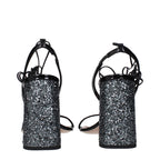 Black leather platform sandals by Miu Miu featuring chunky heels and open toes, stylishly designed for modern fashion.