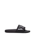 Valentino Garavani black cotton slippers with slip-on design and minimal branding, displayed on a neutral background.