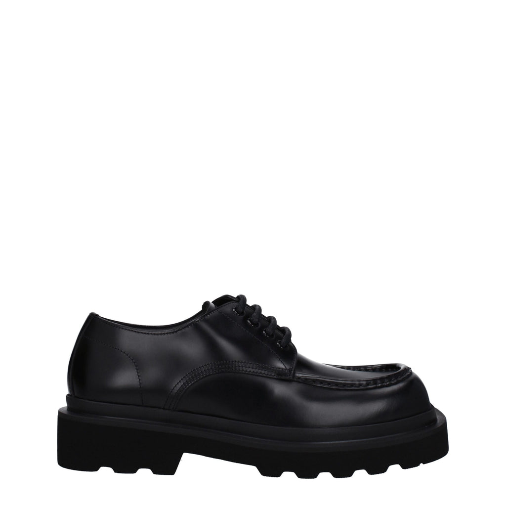 Black leather Dolce & Gabbana oxford shoes and derbies with classic lace-up design and sleek finish.