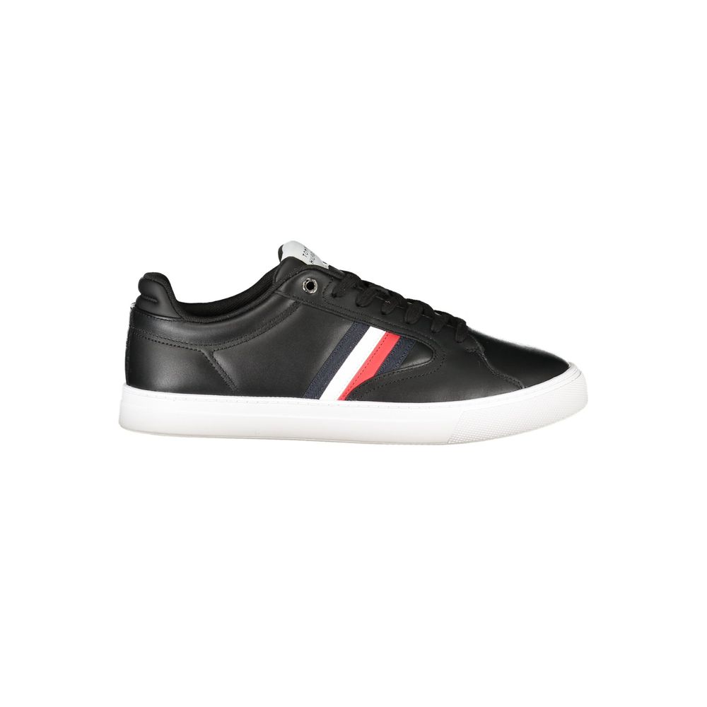 Black Tommy Hilfiger men's polyester sneaker with white sole and branding, viewed from the side.