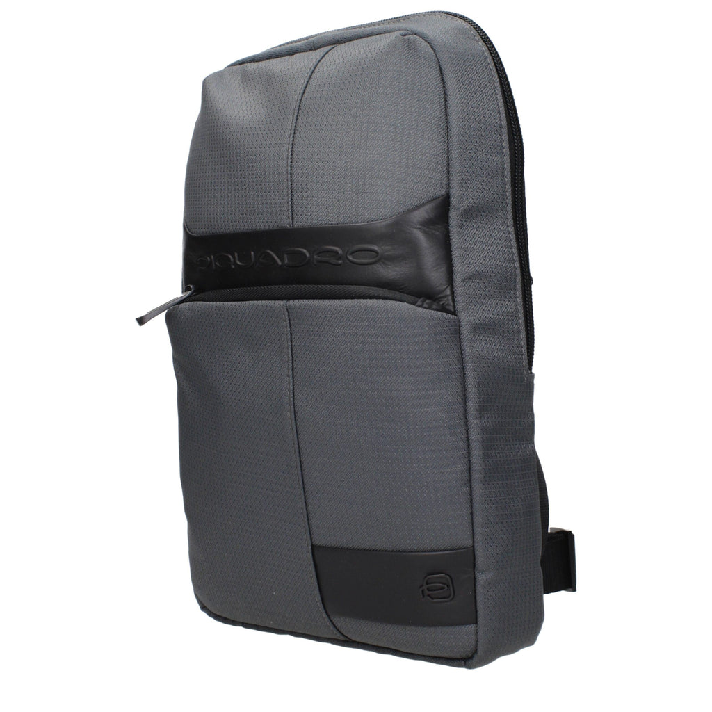 Gray fabric crossbody bag by Piquadro with adjustable strap and sleek design, suitable for everyday use.