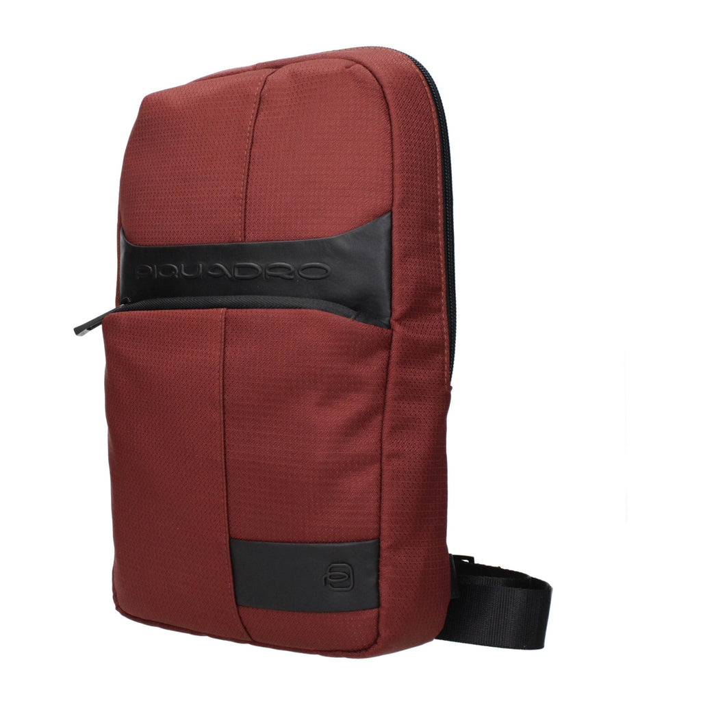 Red fabric Piquadro crossbody bag with adjustable strap and sleek design, ideal for everyday use.