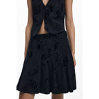 Black polyester women's skirt by Desigual featuring a stylish design, shown on a model with a flowing fit and modern silhouette.
