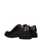 Black leather Church's oxford and derby shoes with polished finish and classic lace-up design, displayed on a neutral background.