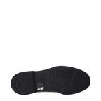 Black leather Oxford and Derby shoes by Church's, showcasing polished formal footwear with classic design details.