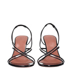 Amina Muaddi black leather stiletto heel sandals featuring sleek straps and a chic, modern design.