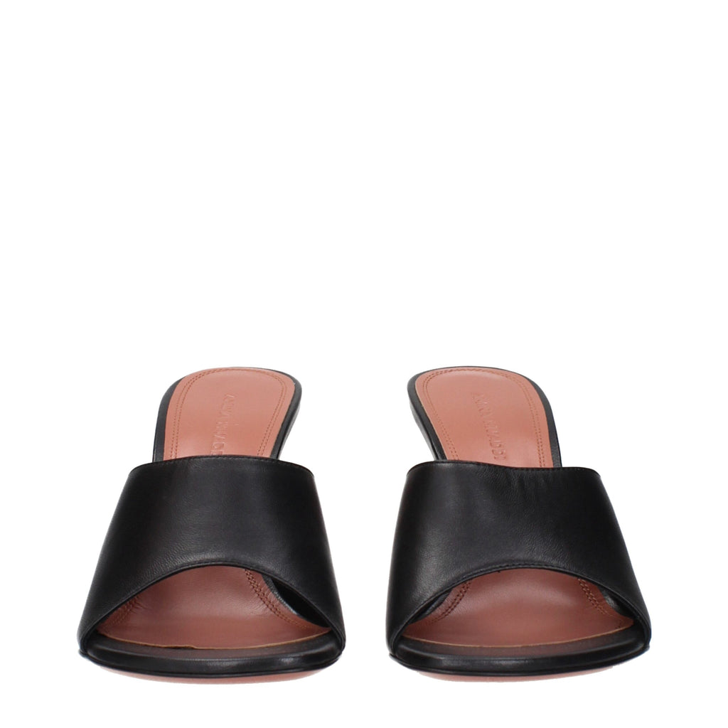 Black leather stiletto heel sandals by Amina Muaddi with sleek straps and pointed toes, stylish and elegant footwear.