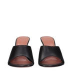 Black leather stiletto heel sandals by Amina Muaddi with sleek straps and pointed toes, stylish and elegant footwear.