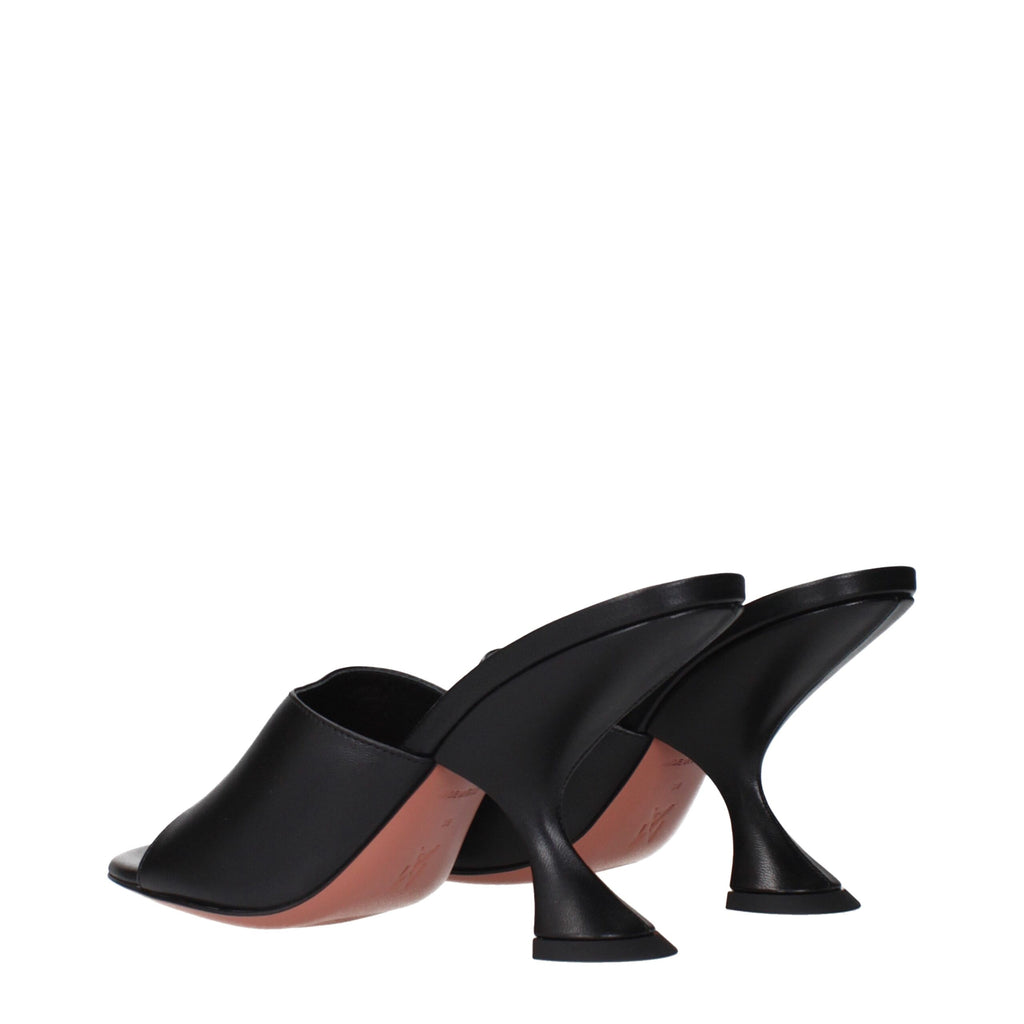 Amina Muaddi black leather stiletto heel sandals with sleek straps and pointed toes, stylish footwear for elegant occasions.