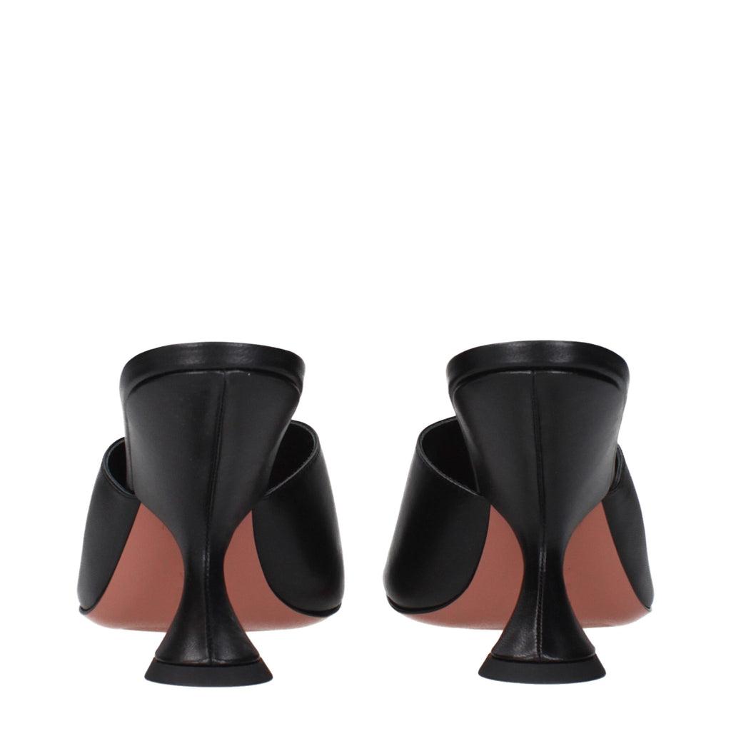 Black leather stiletto heel sandals by Amina Muaddi, featuring sleek straps and elegant design.