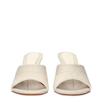 Amina Muaddi beige fabric slippers with open toe design and flat sole, stylish and comfortable for casual wear.