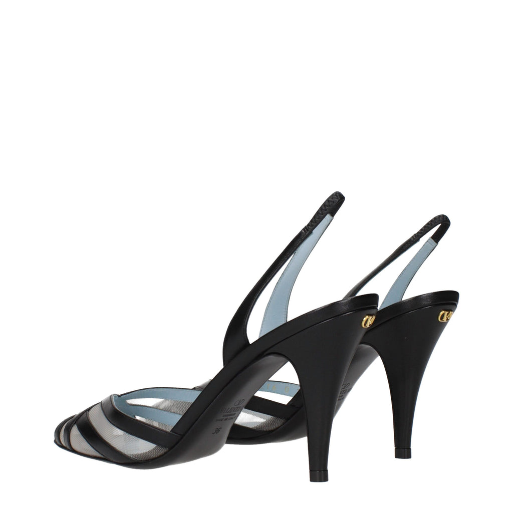 Black leather Valentino Garavani high heel pumps with pointed toes and stiletto heels, elegant footwear for formal occasions.