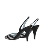 Black leather Valentino Garavani high heel pumps with pointed toes and stiletto heels, elegant footwear for formal occasions.
