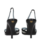 Black leather Valentino Garavani high heel pumps with pointed toes and stiletto heels, showcasing elegant craftsmanship.