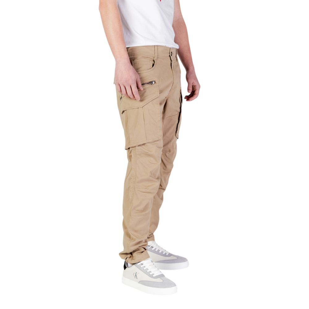 Replay beige cotton cargo pants with multiple pockets and relaxed fit, shown on a model in a casual outdoor setting.