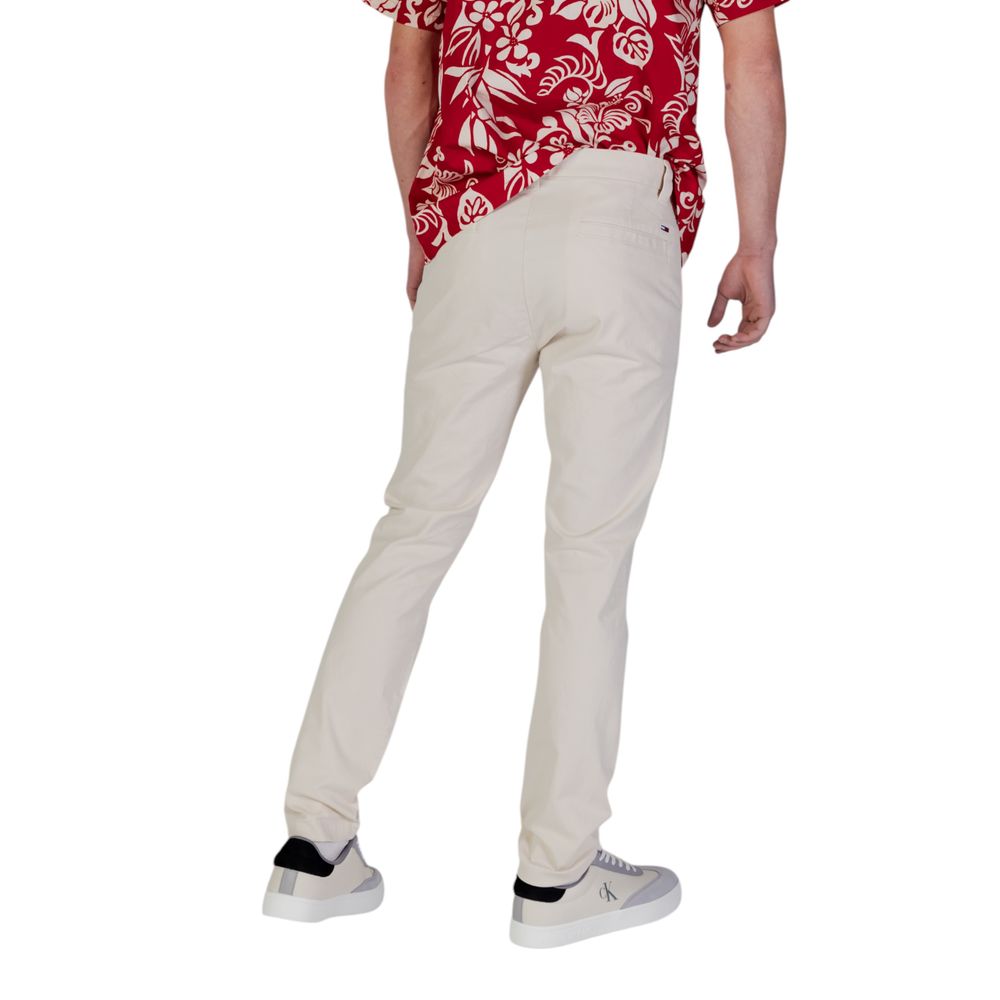 Beige cotton skinny jeans by Tommy Hilfiger Jeans laid flat, showing classic fit and clean stitching details.