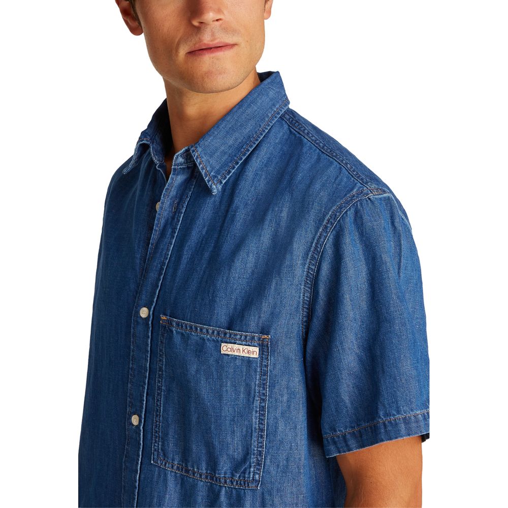 Calvin Klein Jeans blue denim shirt with button-down collar and long sleeves, casual stylish men's denim top.