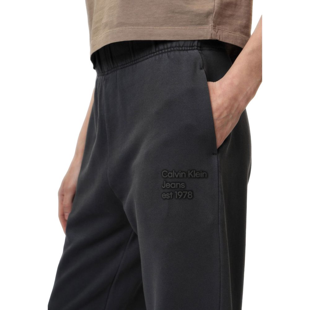 Calvin Klein Jeans gray cotton joggers with an elastic waistband and tapered fit, suitable for casual wear and workouts.
