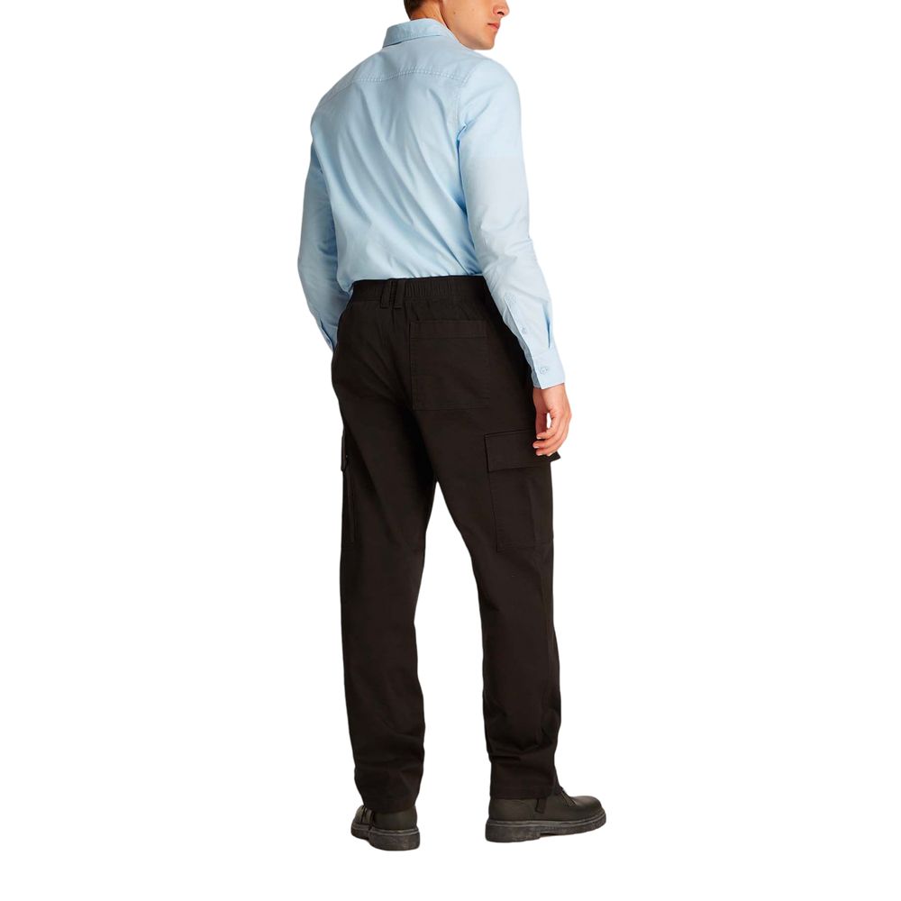 Calvin Klein Jeans black cotton cargo pants with multiple pockets and a relaxed fit, shown on a model.