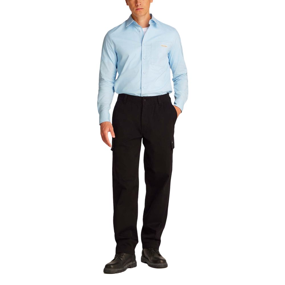 Calvin Klein Jeans black cotton cargo pants with multiple pockets and relaxed fit, displayed on a hanger against a white background.