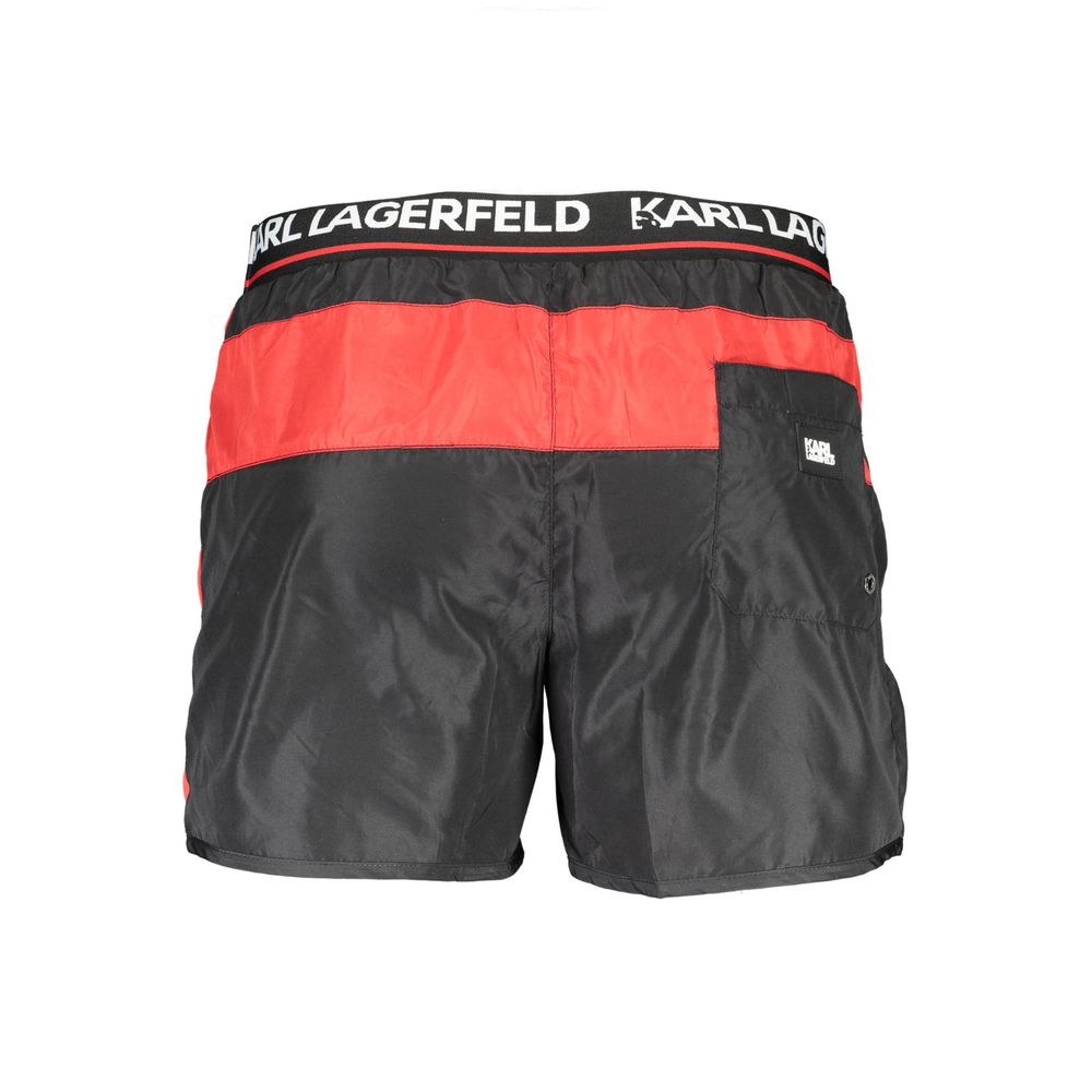 Karl Lagerfeld Nero polyester men's swim boxer, black with logo waistband, shown on model against a beach background.