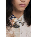 Desigual beige cotton women's shirt with a relaxed fit and stylish design, showcasing casual and comfortable fashion.