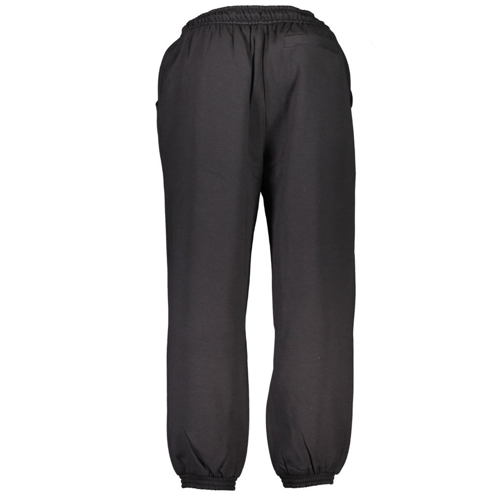 Calvin Klein black cotton men's sweatpants with elastic waistband and relaxed fit, shown on a plain background.