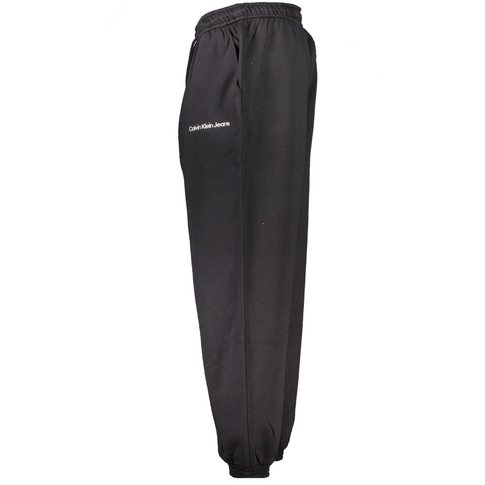 Calvin Klein black cotton men's sweatpants laid flat, showing elastic waistband and relaxed fit.