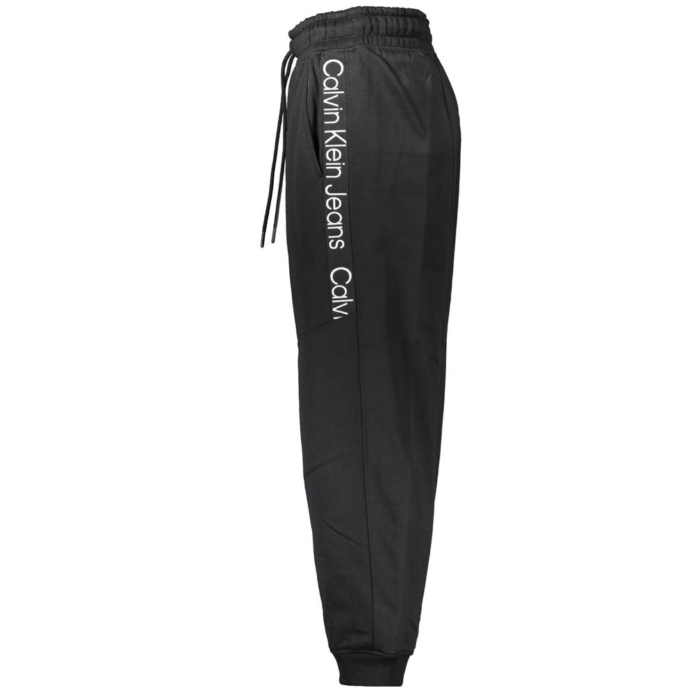Calvin Klein black polyester women's jogger pants with an elastic waistband and tapered fit, shown on a plain background.
