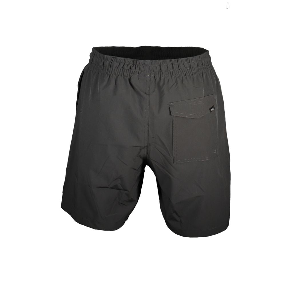 Vans Nero polyester men's sweatpants with elastic waistband and drawstring, casual athletic style, front and side view.