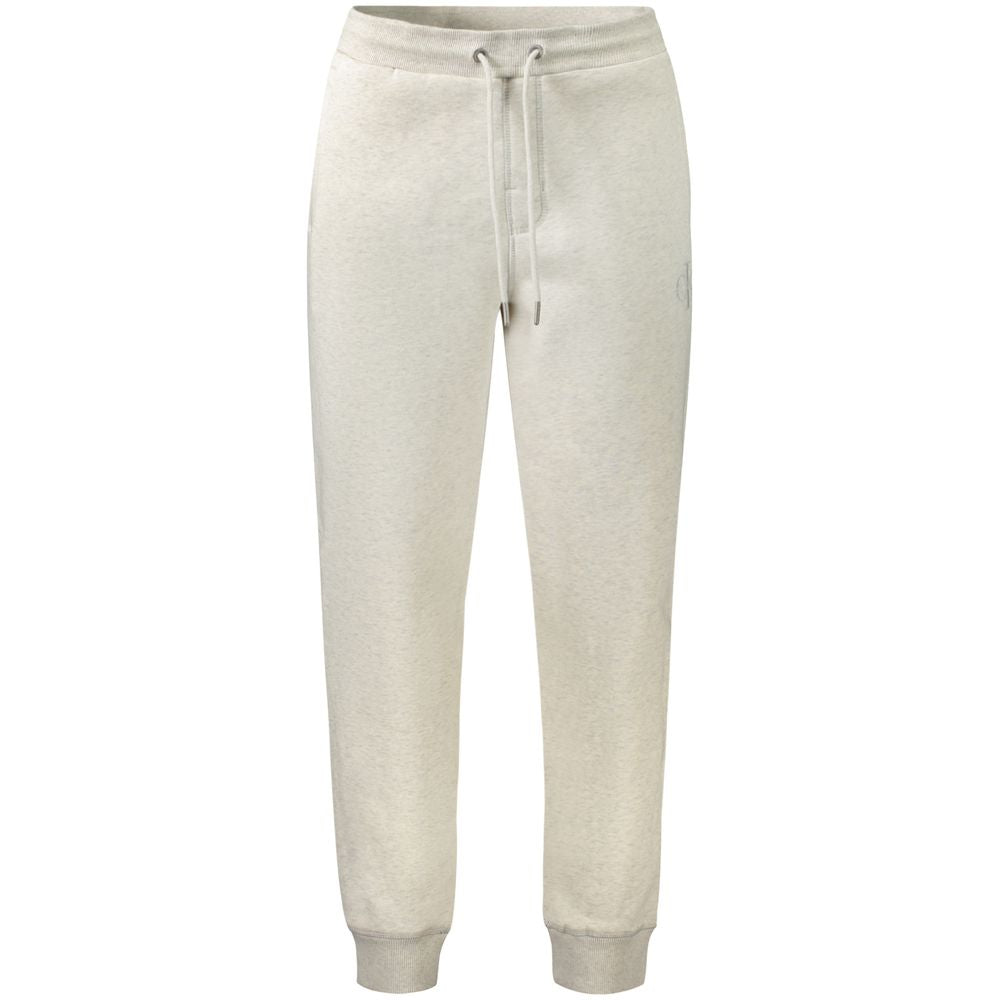 Calvin Klein grey cotton men's jogger pants displayed on a hanger, showing the relaxed fit and elastic waistband.