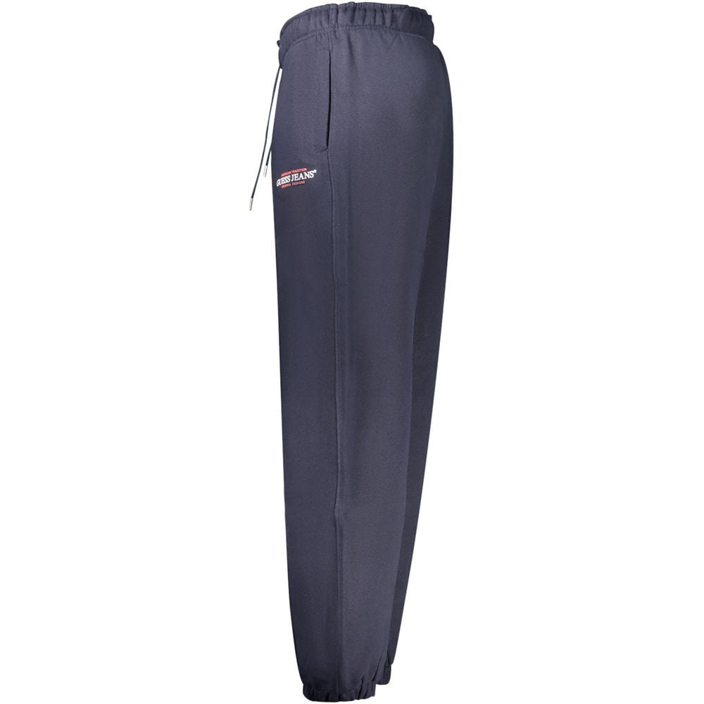 Blue cotton men's track pants by Guess Jeans, featuring a relaxed fit with elastic waistband and side pockets.
