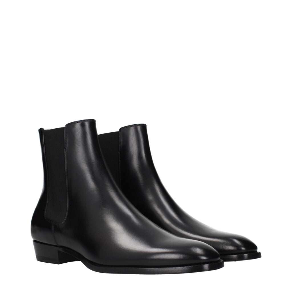 Black leather ankle boots by Celine with sleek design, pointed toes, and low block heels, perfect for stylish everyday wear.