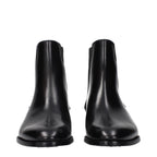 Black leather ankle boots by Celine featuring sleek design and low block heel, perfect for stylish everyday wear.