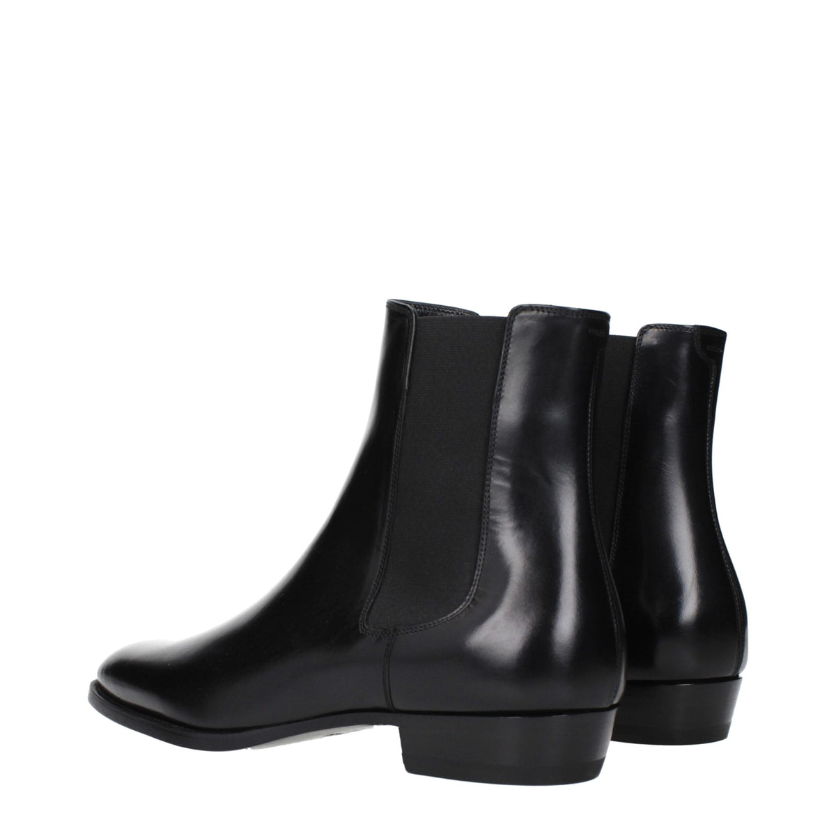 Black leather ankle boots by Celine with sleek design and pointed toes, featuring subtle stitching and low block heels.