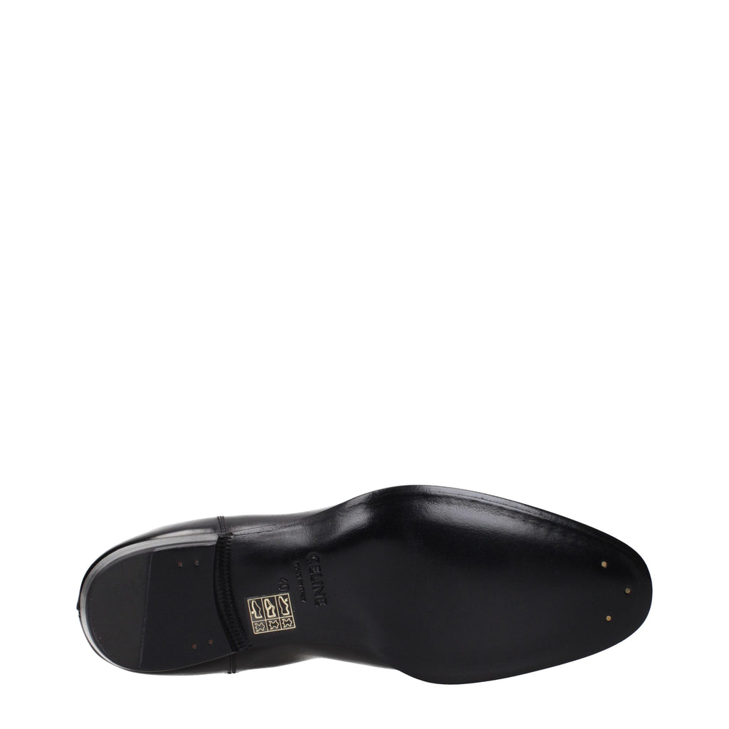 Black leather ankle boots by Celine featuring sleek design and pointed toes, perfect for stylish everyday wear.