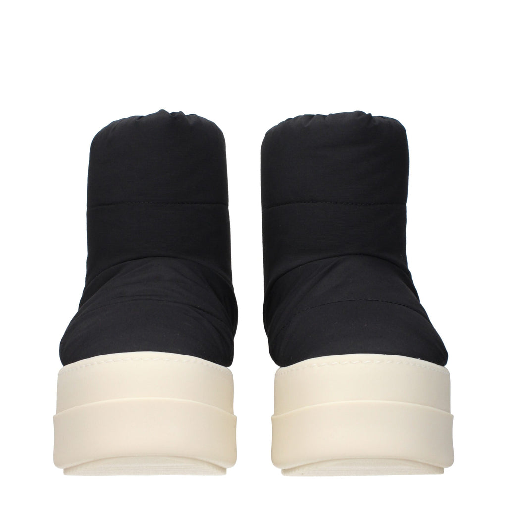Rick Owens black fabric ankle boots with sleek design and pointed toes, shown on a plain background.