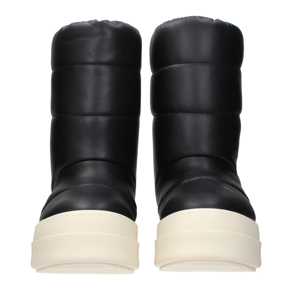 Black leather ankle boots by Rick Owens featuring sleek design and pointed toes, perfect for modern fashion styles.