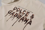 Dolce & Gabbana ivory cotton crewneck sweater with printed design, close-up view of the fabric and neckline.