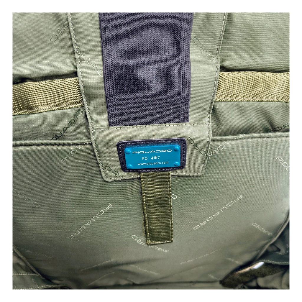 Gray fabric Piquadro backpack with adjustable straps and multiple compartments, designed for everyday use and style.