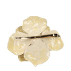 Valentino Garavani beige metal brooch featuring a sleek, elegant design with intricate detailing and a secure pin back.