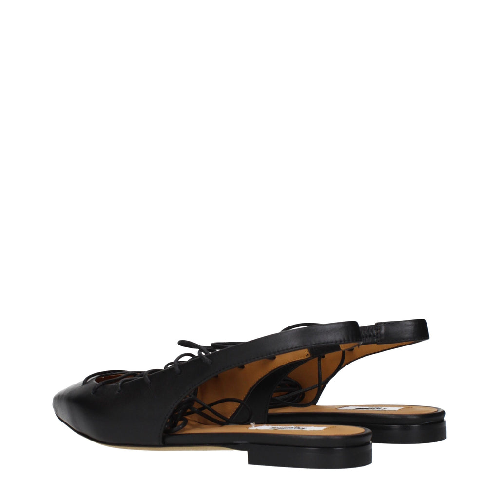 Black leather flats by Moschino featuring a sleek design and classic silhouette, perfect for stylish everyday wear.