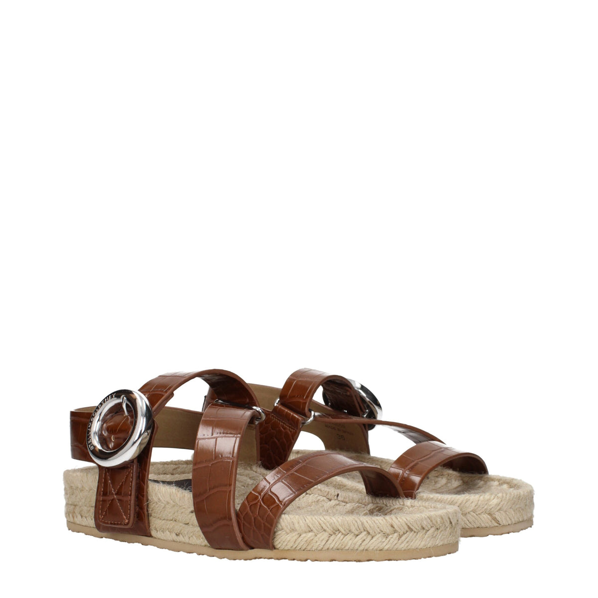 Stella McCartney brown leather flat sandals with minimalist design and open toe, showcasing their sleek, comfortable style.