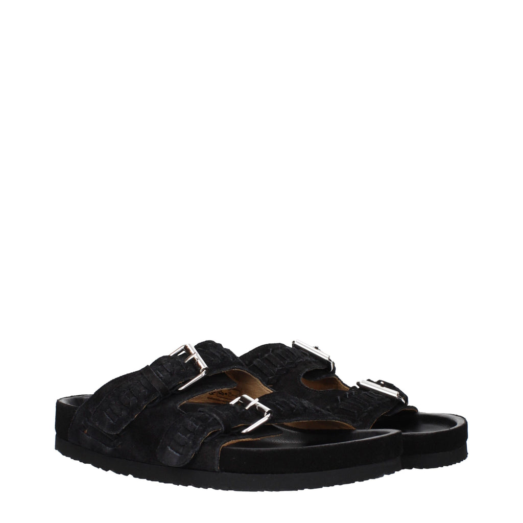 Black leather slippers by Isabel Marant featuring a sleek design and comfortable slip-on style.