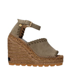 Stella McCartney green leather wedge sandals with ankle straps and open toe design.