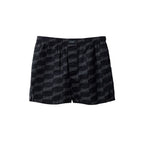 Black cotton Bermuda shorts by Balenciaga featuring a relaxed fit and classic design, shown on a model.
