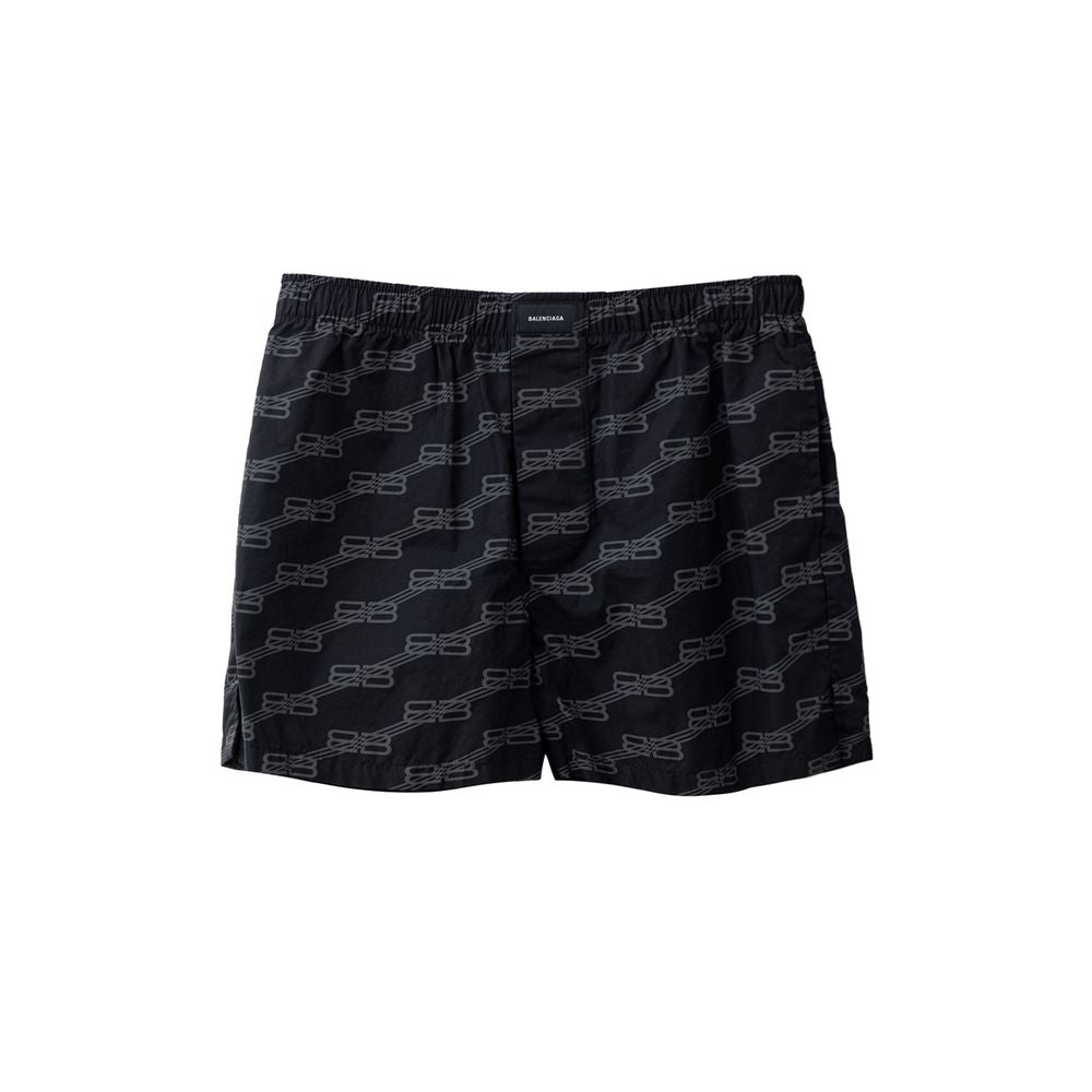 Black cotton Bermuda shorts by Balenciaga featuring a relaxed fit and classic design, shown on a model.