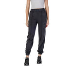 Guess Active black polyester joggers for women, featuring a relaxed fit and athletic style suitable for workouts and casual wear.