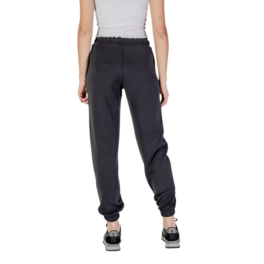 Guess Active black polyester joggers with a tapered fit and elastic waistband, designed for comfortable workout and athletic wear.